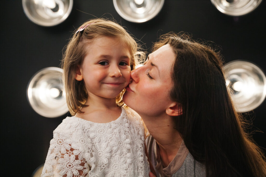 mother kid kissing indoors