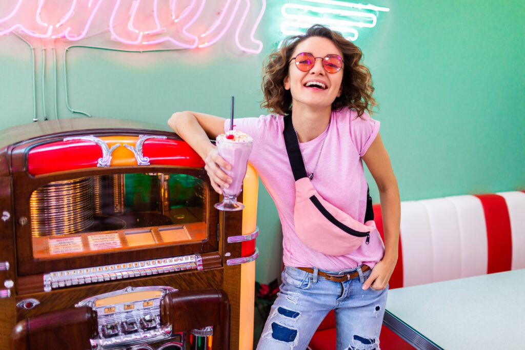 woman retro vintage 50 s cafe music jukebox drinking milk shake cocktail hipster outfit having fun laughing cheerful mood
