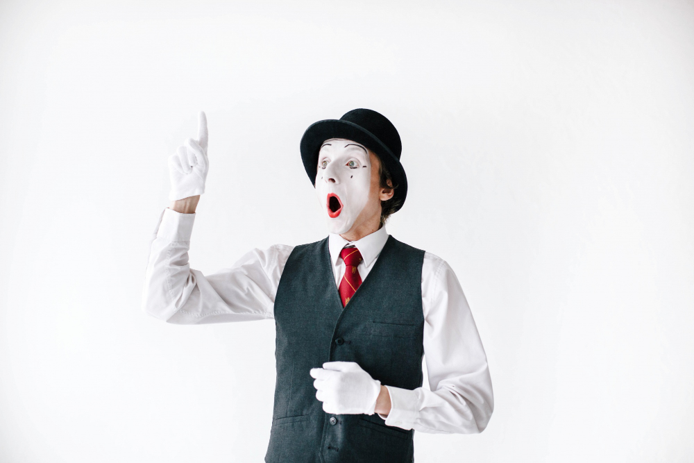 surprised mime holds his finger up